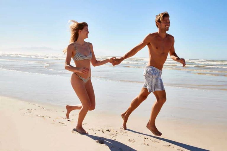 couple running in beach